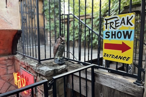 Sign that saays 'ffreak show entrance' with an arrow pointing to the right